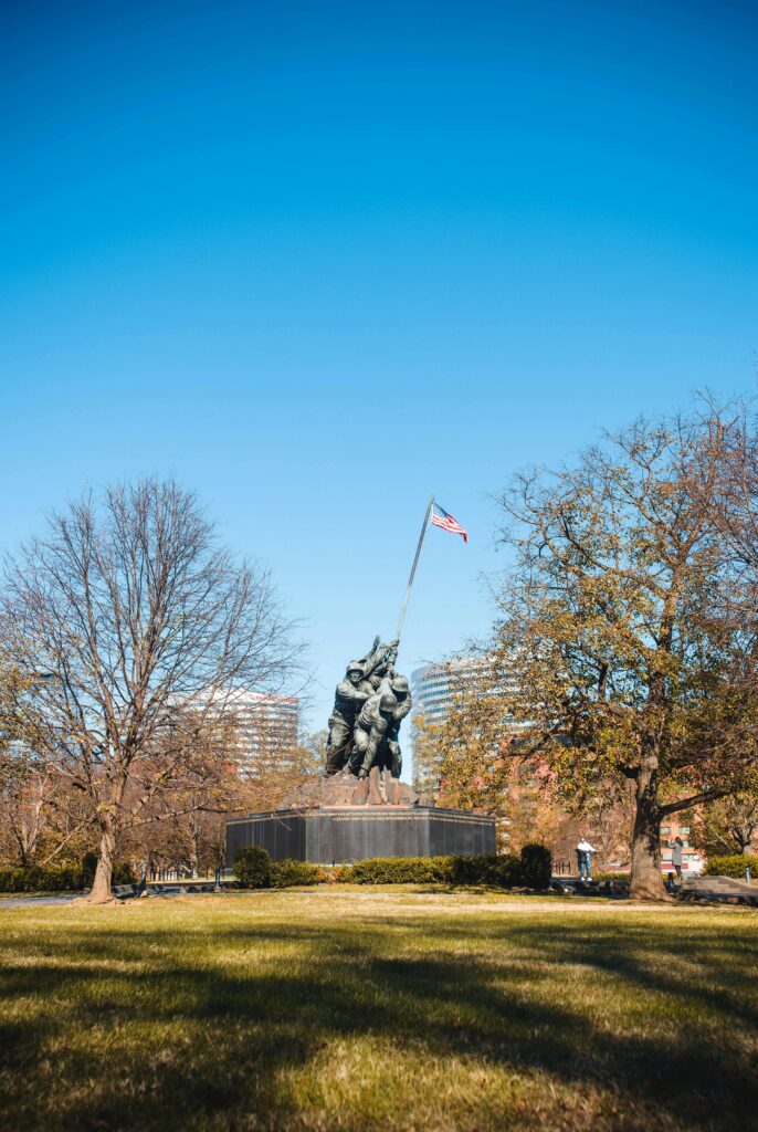 A peaceful view of the US Marine Corps War Memorial located in Washington, DC during a clear day.