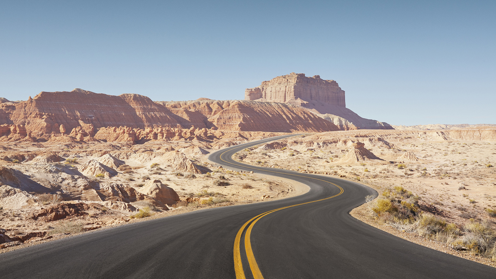 winding empty road through arid desert landscape